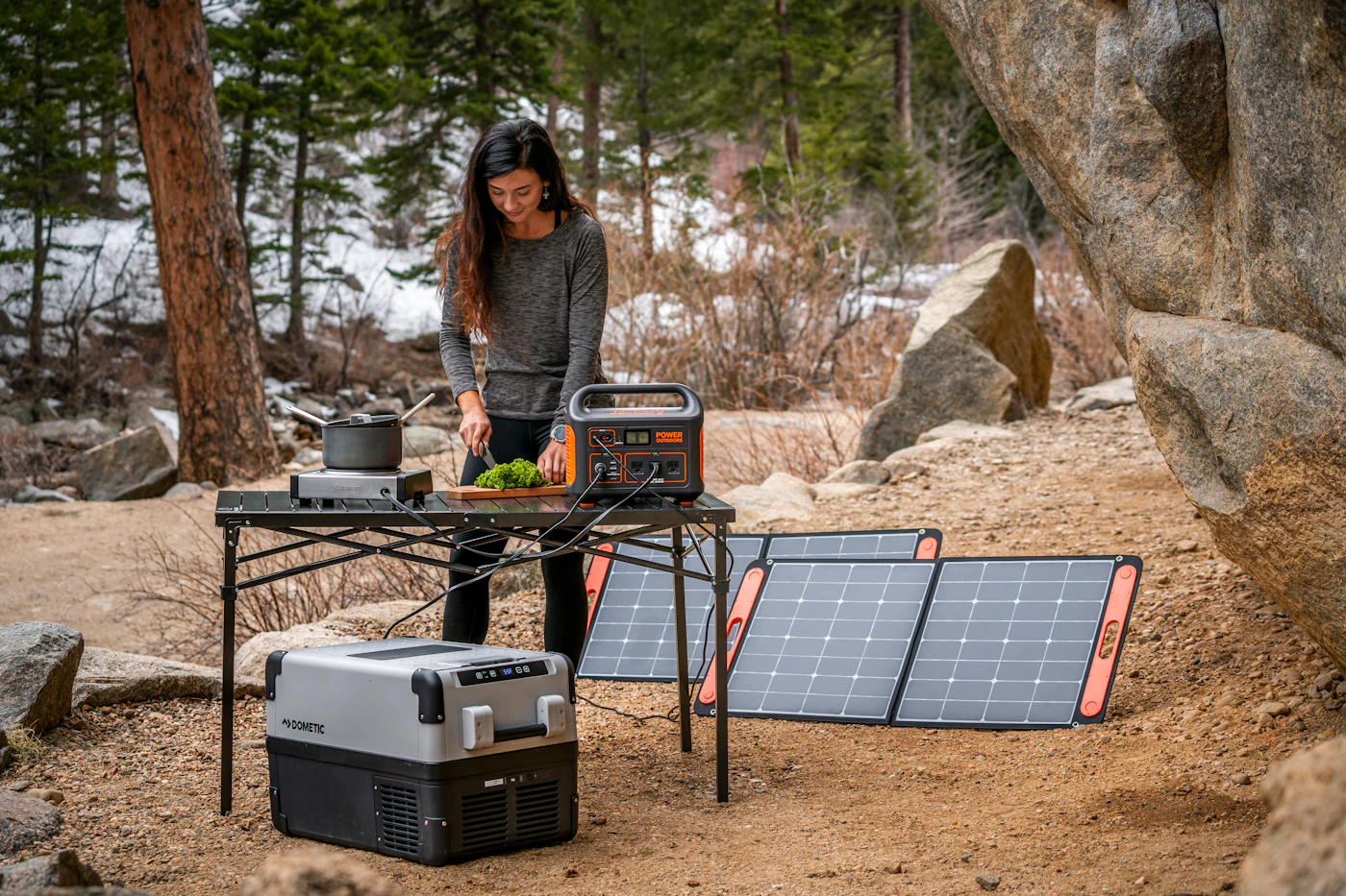 Portable power station at a forest campsite; illustrative setup